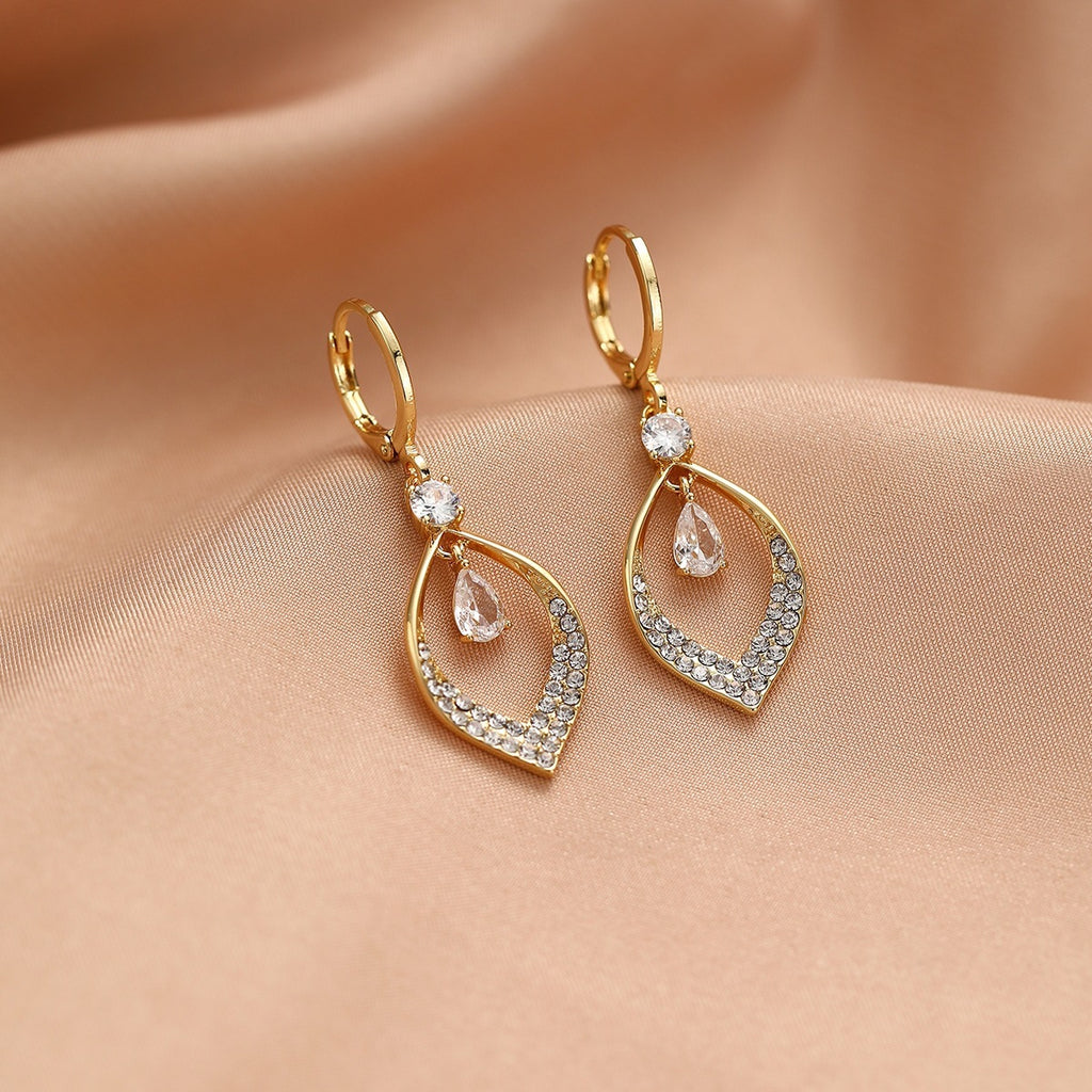 A Woman With Elegant Zircon Water Drop Tassel Earrings